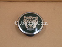 WHEEL EMBLEM BADGE FOR CENTER OF WHEEL SILVER HEAD GREEN BACKGROUND  C2C30080